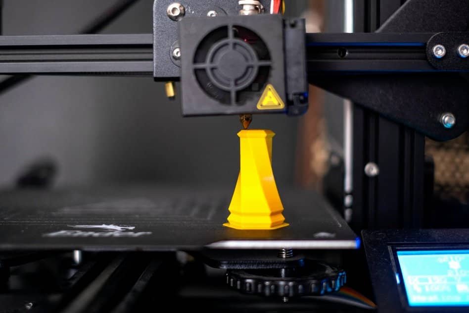 3d printer making yellow figure