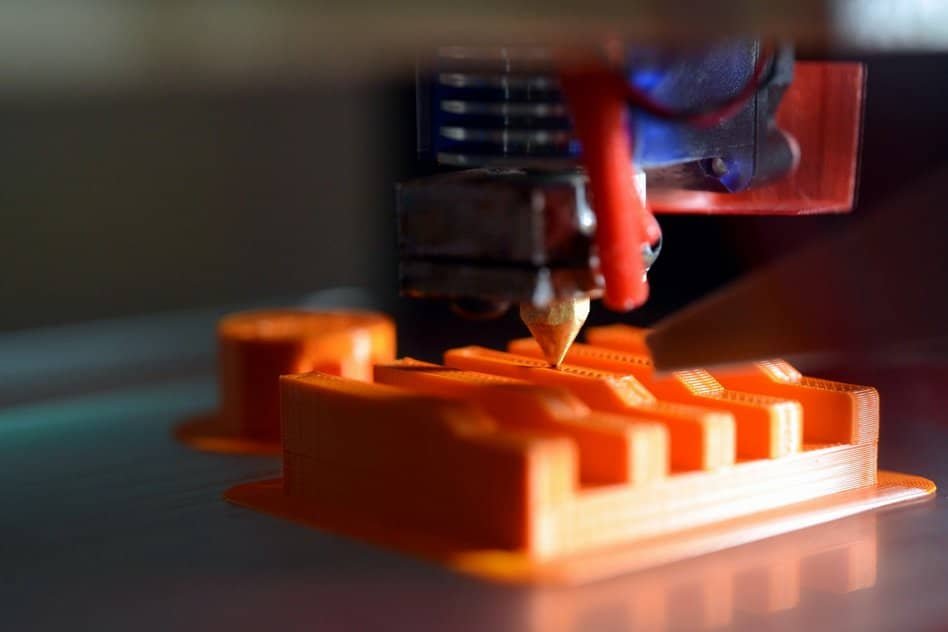 3d printer printing orange figure