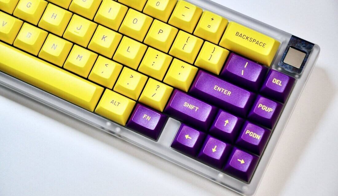 desktop keyboard with yellow and violet keys